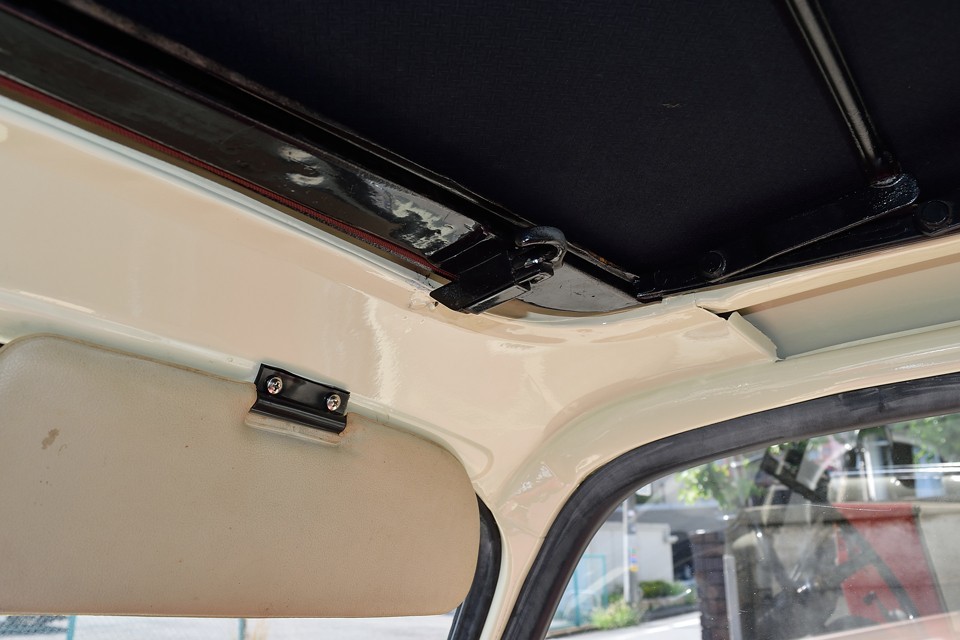 キャンバストップの開閉は、このストッパーを手前に引いて外し、「エイヤッ！」と開けるだけ。あとはキャンバスがシワにならないように畳むか、丸めればＯＫ！いたってシンプル！