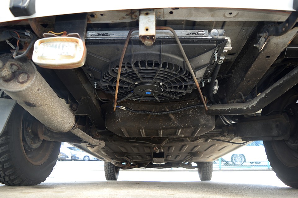 そしてそして、ラジエター後面の取付ではNGだったコンデンサー＆電動ファンは、スペアタイヤのスペースに設置！ピッタリと収まって最低地上高に変化は無いし、何より直接外気に触れるので、冷えるのです！